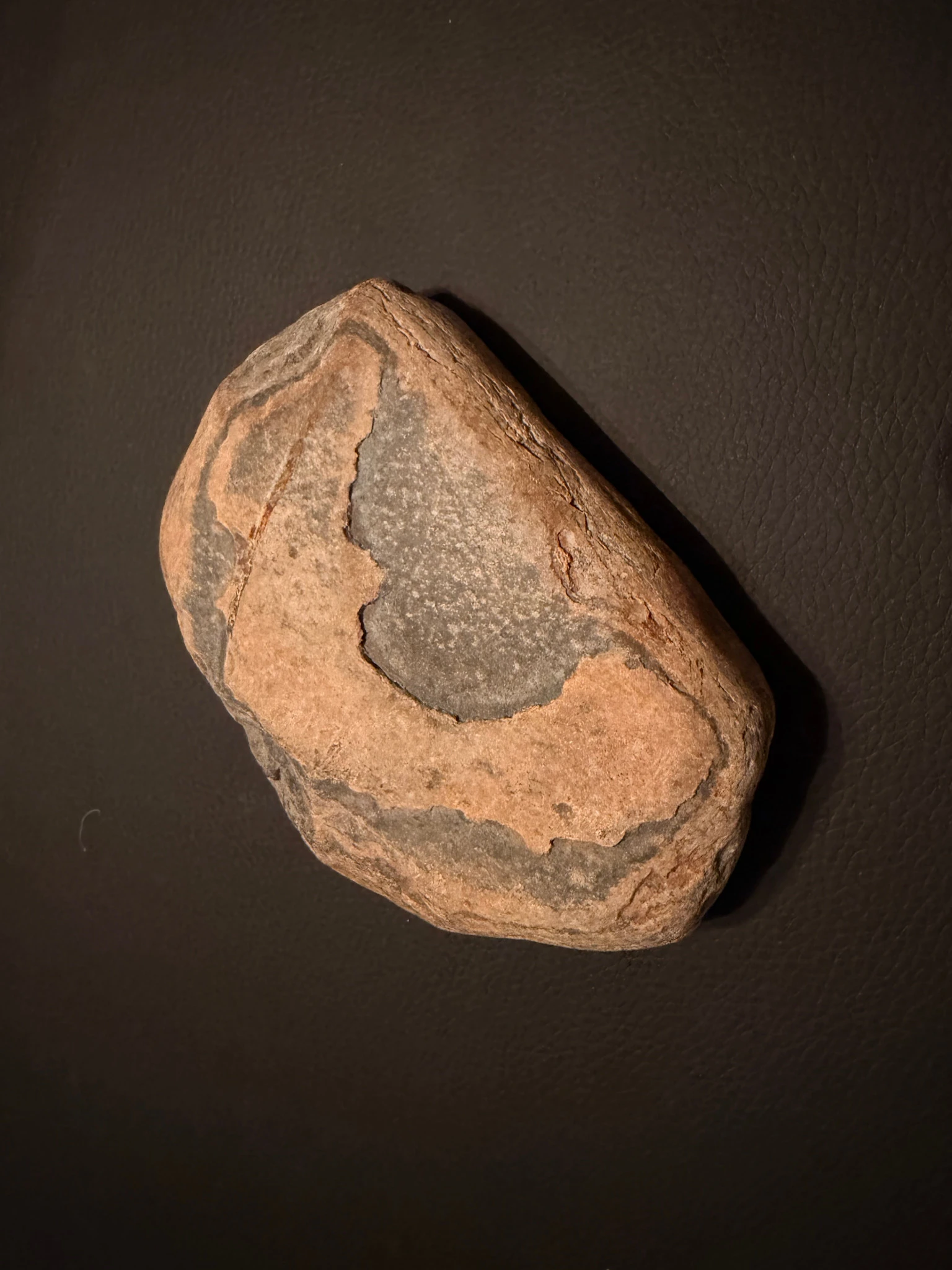 Rounded beach stone from Casco Bay with a distinct gray surface marking